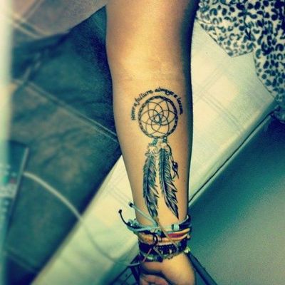  Tatouage attrape rêve avec des écritures sur l'avant bras